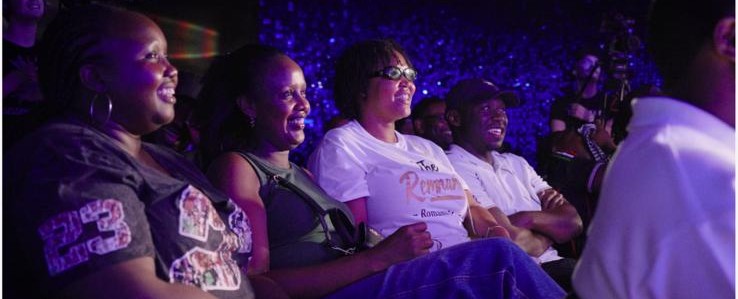 The audience laughing at a David Babu show